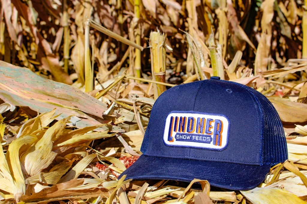 Solid Navy Trucker cap with Lindner Show Feeds patch